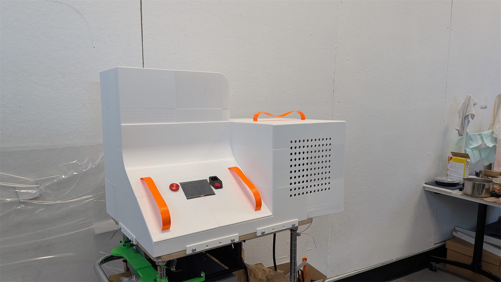 Finished PlastiVista machine enclosure with touchscreen and orange handles.