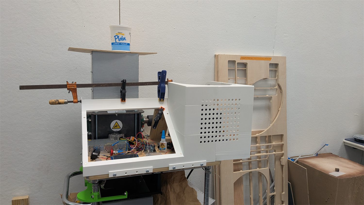 Open PlastiVista machine enclosure showing internal electronics and workspace.