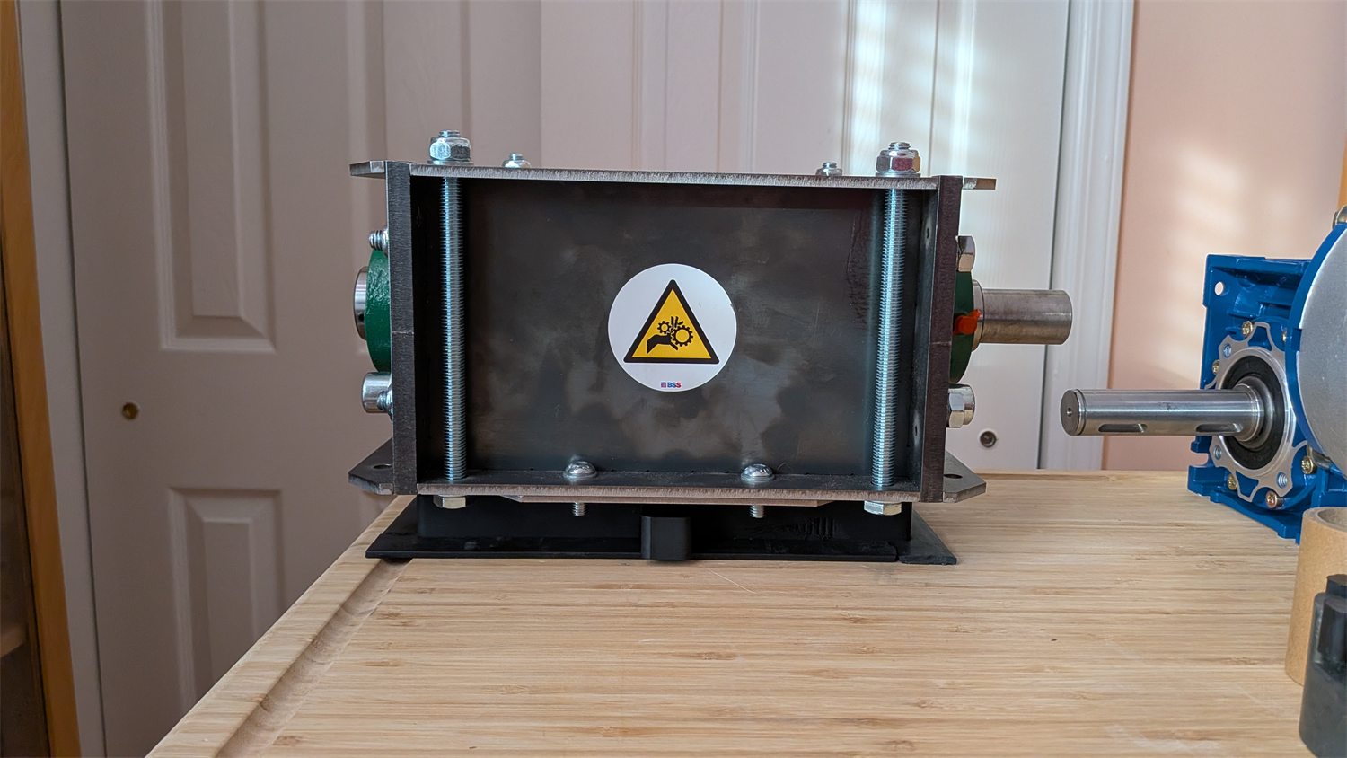 Shredder housing and blade assembly mounted in a fabricated frame.